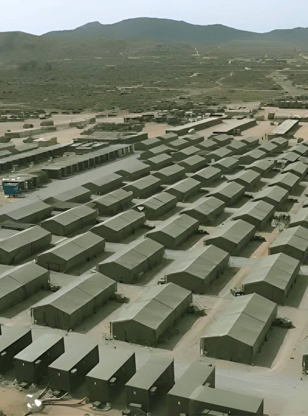 Aerial view of a modular base camp in mountainous terrain