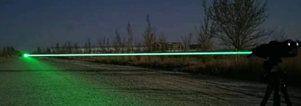 Laser jammer beam across a field at night